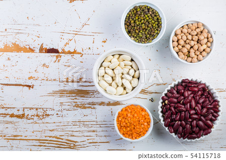 Selection of colorful beans on white wood background Selection of colorful beans on white wood background 54115718