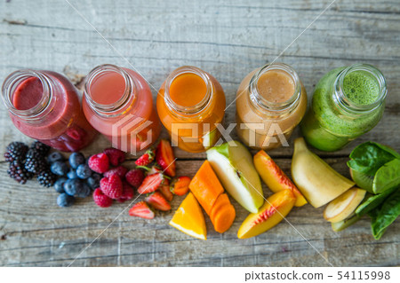 Selection of colourful smoothies on rustic wood background 54115998