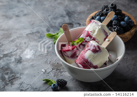 Berry popsicles on rustic background 54116214