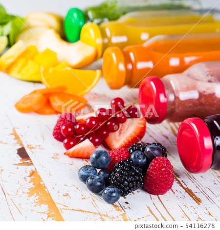 Selection of colourful smoothies on rustic wood background 54116278