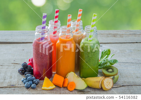Selection of colourful smoothies on rustic wood background 54116382