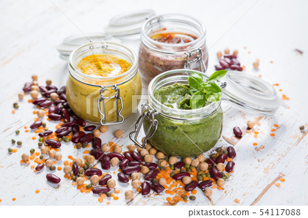 Selection of colorful hummus in jars Selection of colorful hummus in jars 54117088