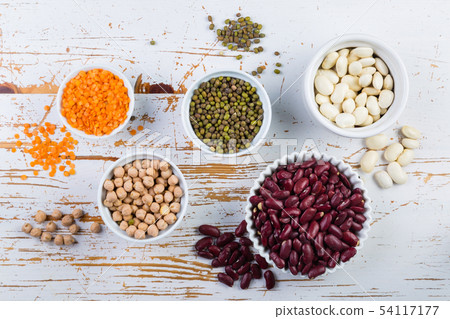 Selection of colorful beans on white wood background 54117177