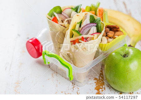 Lunch to go with tortilla wraps and vegetables 54117297
