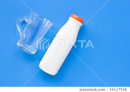 Milk bottle with glass on white 54117536