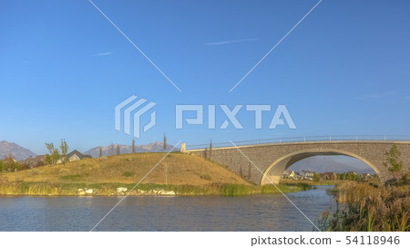 Scenic view with arched bridge over Oquirrh Lake 54118946