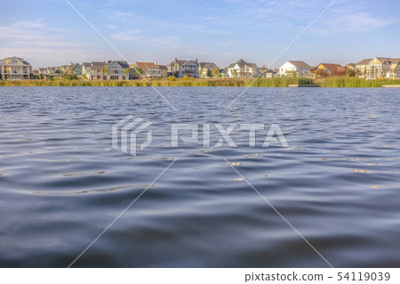Rippling water of Oquirrh Lake with home and sky 54119039