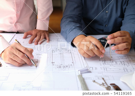 architect engineer team working on house blueprint of real estate project at workplace. construction & building concept architect engineer team working on house blueprint of real estate project at workplace. construction & building concept 54119165