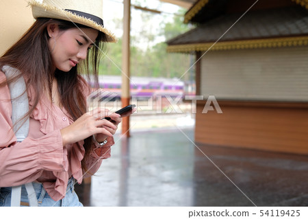 woman traveler with backpack use mobile smart phone at train station. trip journey travel concept woman traveler with backpack use mobile smart phone at train station. trip journey travel concept 54119425