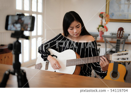 blogger live broadcasting music instrument tutorial on social media. vlogger recording online vlog video. blogger live broadcasting music instrument tutorial on social media. vlogger recording online vlog video. 54119704