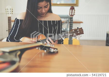 woman playing guitar. leisure lifestyle concept woman playing guitar. leisure lifestyle concept 54119721