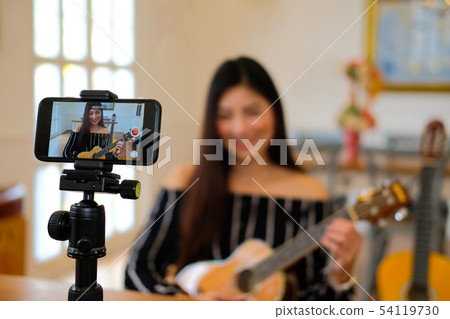 blogger live broadcasting music instrument tutorial on social media. vlogger recording online vlog video. blogger live broadcasting music instrument tutorial on social media. vlogger recording online vlog video. 54119730