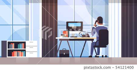 businessman sitting at workplace desk rear view business man using computer while talking on 54121400