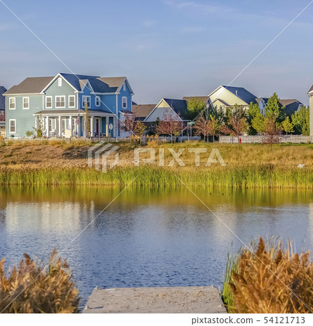 Oquirrh Lake with a wooden deck and lovely homes 54121713