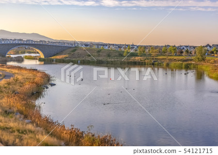 Oquirrh Lake view with lakeside trail and bridge 54121715