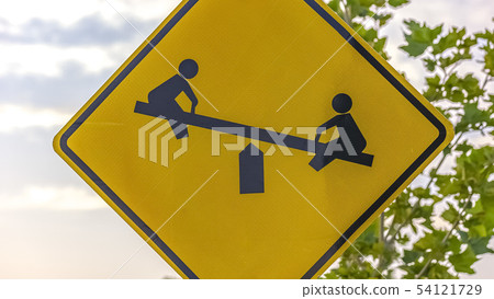 Playground sign with tree and sky in background 54121729
