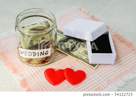 Wedding word, coins and dollar bill in a glass jar Wedding word, coins and dollar bill in a glass jar 54122725