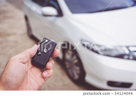 Man holding car keys with car on background 54124044
