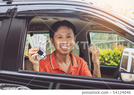 Man showing keys from car and dollar bunch 54124046