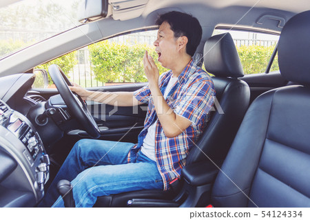 Tired young asia man driving his car Tired young asia man driving his car 54124334