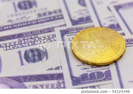 Golden bitcoin coin on us dollars 54124346