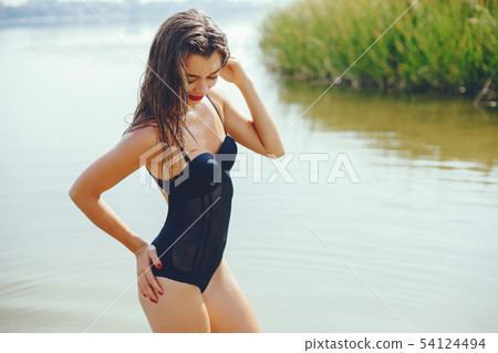 Elegant woman in a sunny beach Elegant woman in a sunny beach 54124494