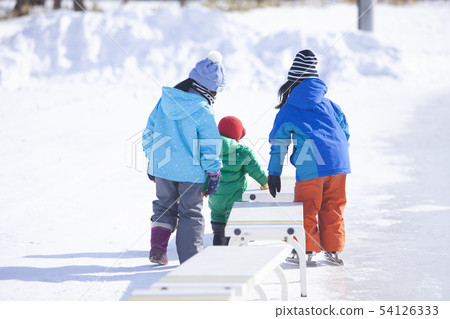 Children playing on the skating rink Children playing on the skating rink 54126333