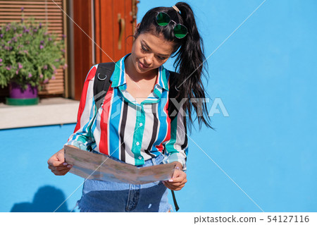 A girl with a backpack visits a colorful Italian A girl with a backpack visits a colorful Italian 54127116