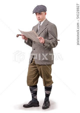 young man in vintage clothes with hat, reading a 54128927