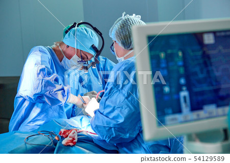 Electrocardiogram in hospital surgery operating emergency room showing patient heart rate with blur Electrocardiogram in hospital surgery operating emergency room showing patient heart rate with blur 54129589