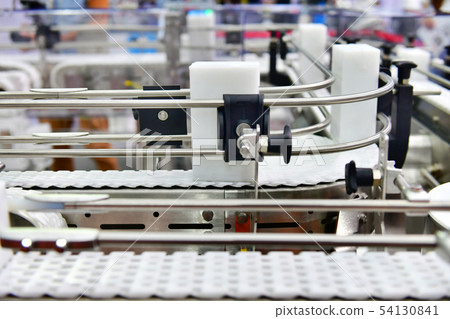 White plastic box on conveyor belt White plastic box on conveyor belt 54130841