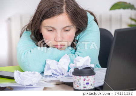 bored teenage girl is doing her homework 54131182