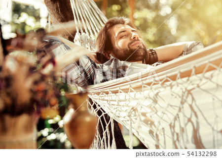 Nice happy man sleeping in the hammock 54132298