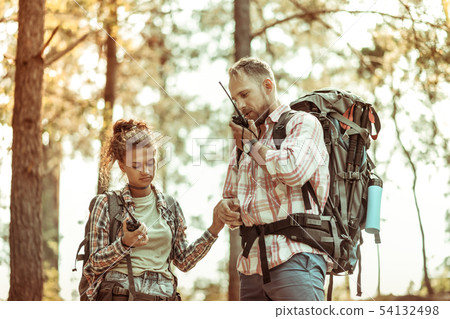 Nice young couple being lost in the forest Nice young couple being lost in the forest 54132498