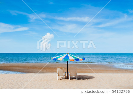Beach beds and colourful umbrella with ocean Beach beds and colourful umbrella with ocean 54132796