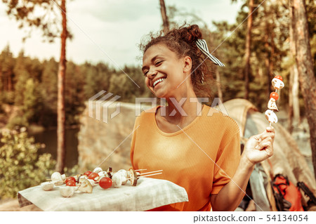 Nice happy girl wanting to grill vegetables Nice happy girl wanting to grill vegetables 54134054