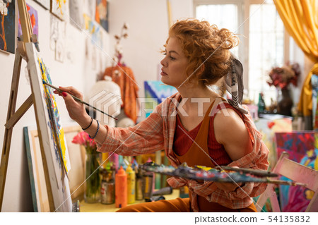 Artist wearing stylish shirt feeling involved in painting 54135832