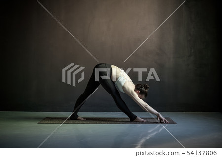 Woman in Wide Legged Forward Bend exercise, Prasarita Padottanasana pose Woman in Wide Legged Forward Bend exercise, Prasarita Padottanasana pose 54137806