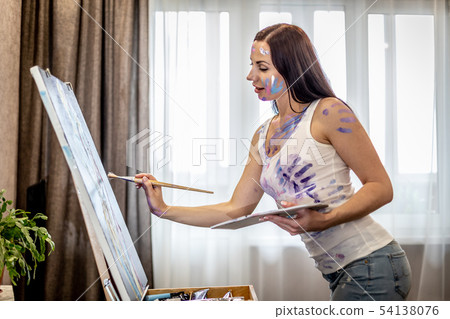Young woman artist painting at home creative tools close-up Young woman artist painting at home creative tools close-up 54138076