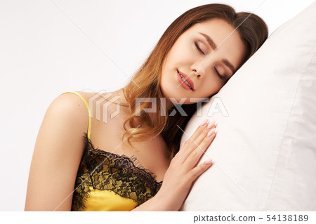 woman slightly smiling put her head on the pillow  woman slightly smiling put her head on the pillow  54138189
