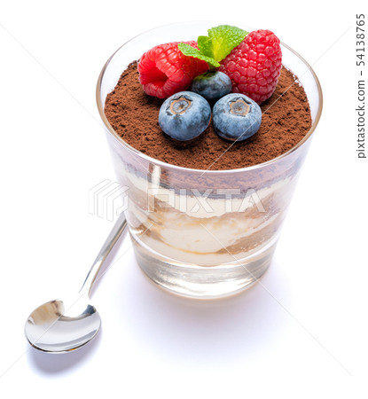 Classic tiramisu dessert with blueberries and raspberries in a glass isolated on a white background 54138765