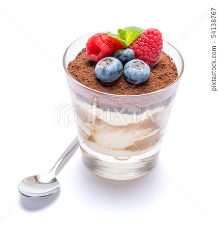 Classic tiramisu dessert with blueberries and raspberries in a glass isolated on a white background 54138767