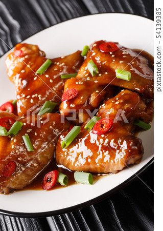 Asian chicken wings in teriyaki sauce close-up on 54139385