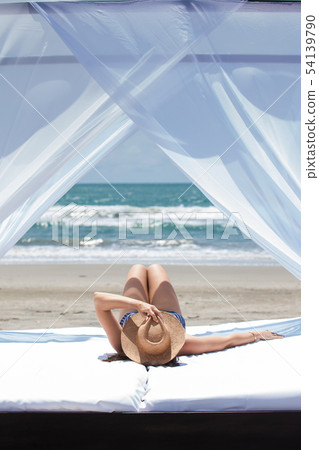 Woman relaxing at a paradisiac tropical beach 54139790