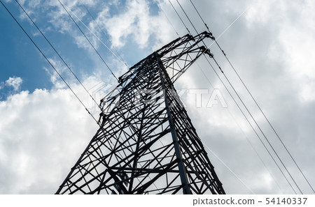 A high-voltage electricity pylon against blue sky 54140337