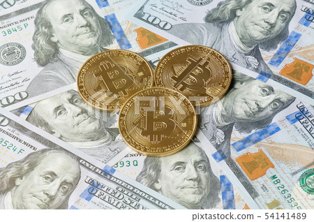 Golden bitcoin coins on US hundred dollar. Golden bitcoin coins on US hundred dollar. 54141489