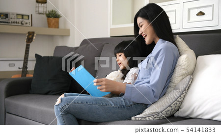 Family concept. Mother and daughter are reading Family concept. Mother and daughter are reading 54141833
