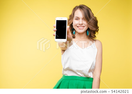 Girl showing mobile to the camera with shocked 54142021