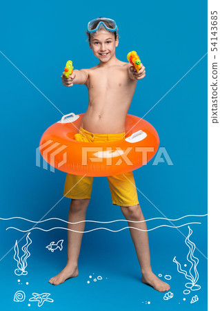 Cheerful teenage boy resting in water, shooting with water guns at camera Cheerful teenage boy resting in water, shooting with water guns at camera 54143685