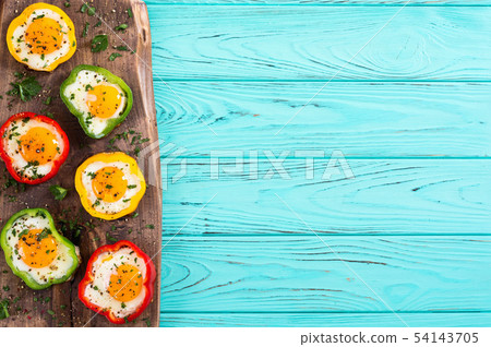 Yellow , red and green pepper with fried eggs Yellow , red and green pepper with fried eggs 54143705